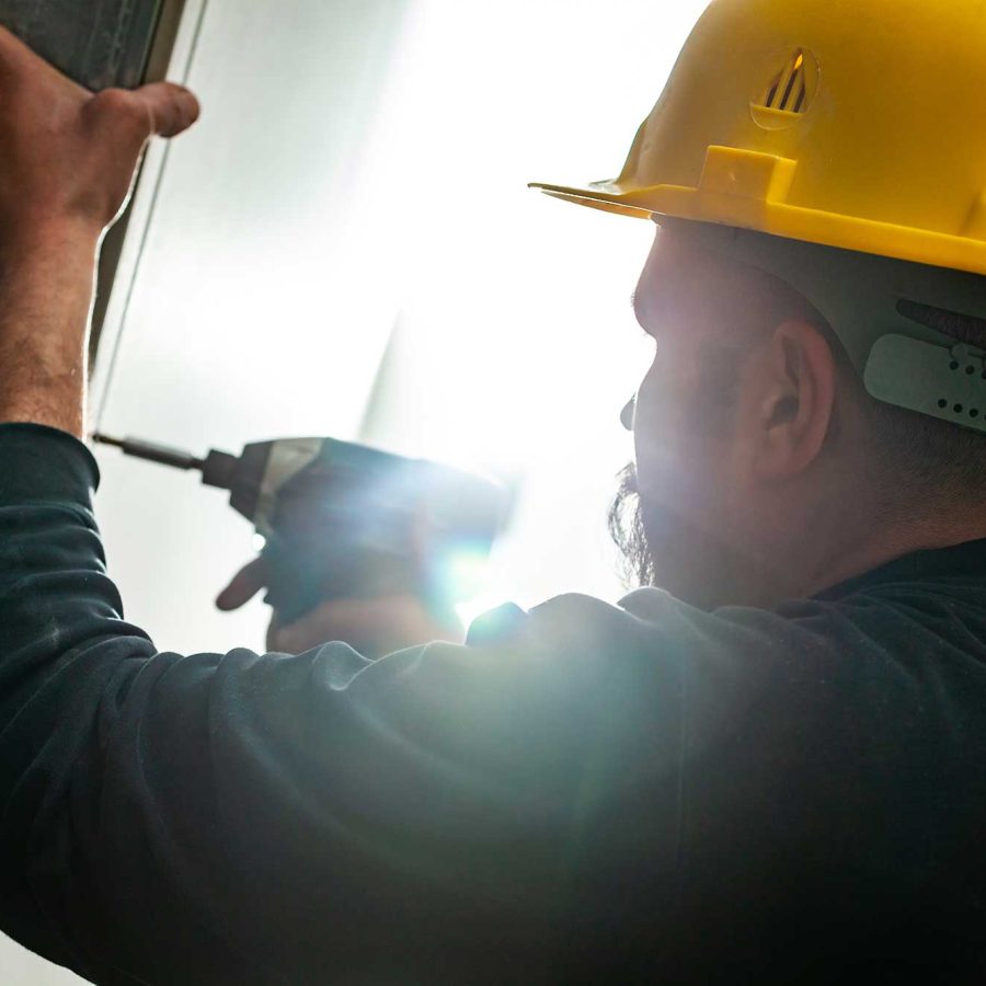 Worker builds a plasterboard wall